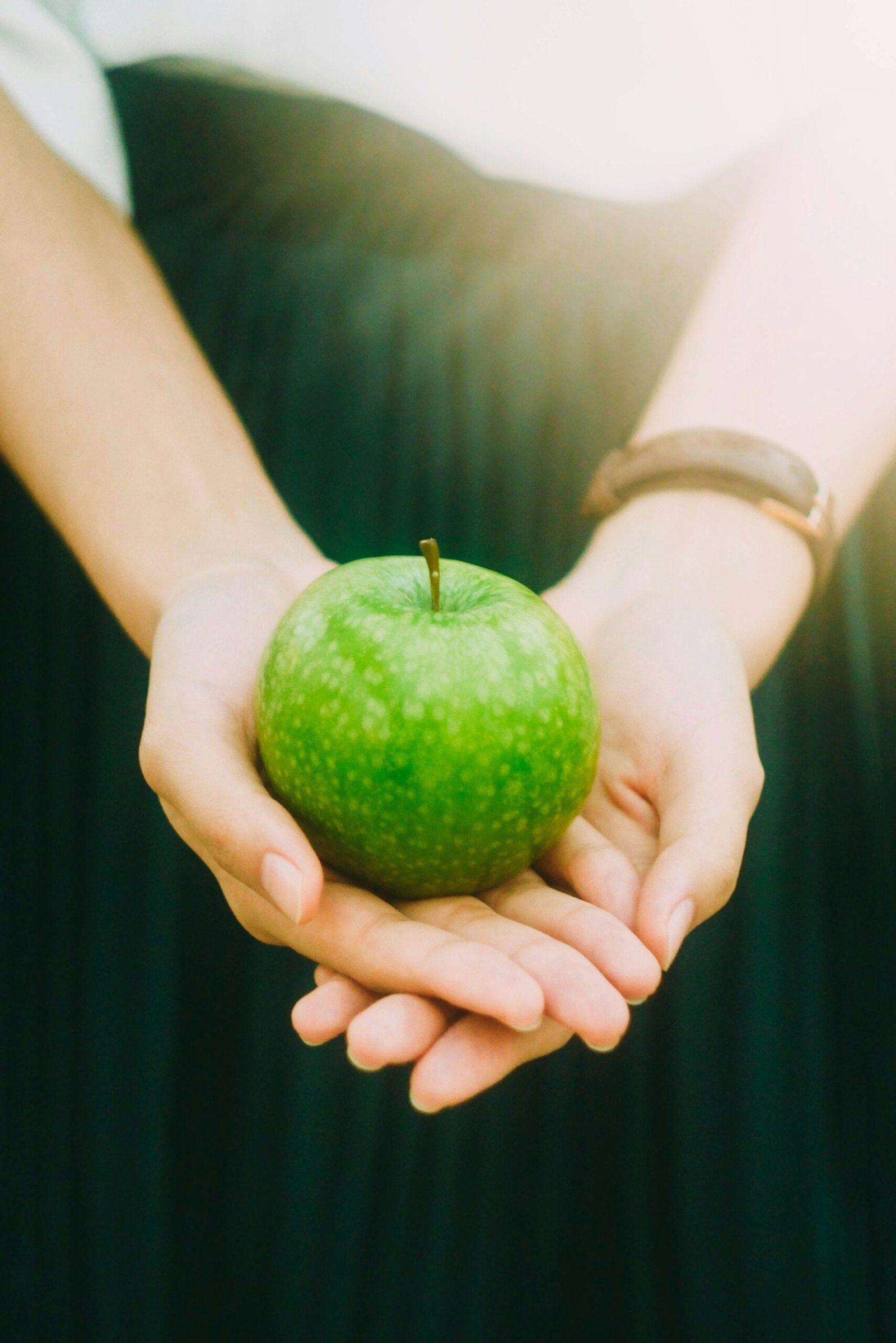 green-apple-hands-stock-unsplash-health-nutritional-services
